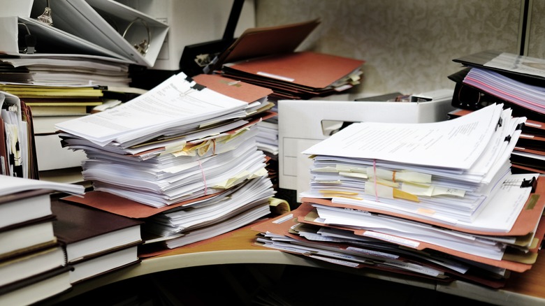 Stacks of papers on a shelf