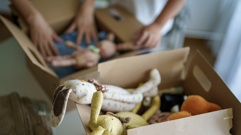 Sorting toys into cardboard boxes
