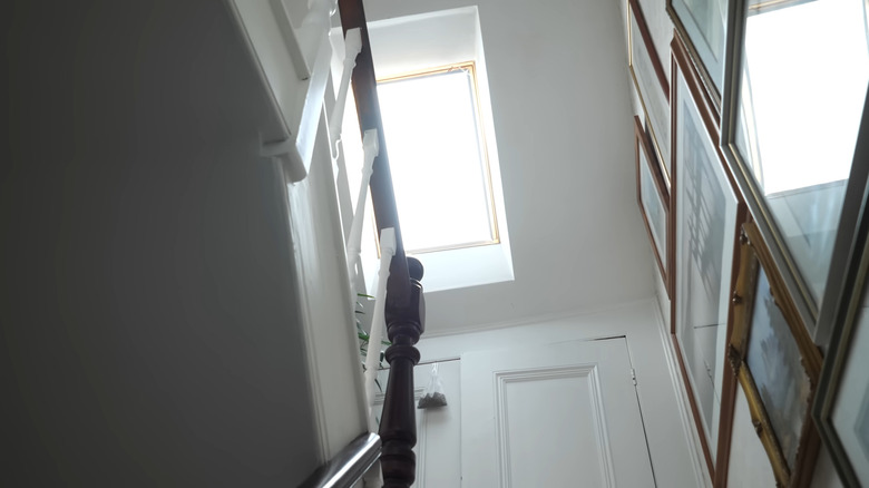Man holding the edge of large bright LED light made from a TV on a table top