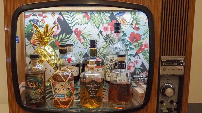 TV turned into a bar with a tropical flamingo background