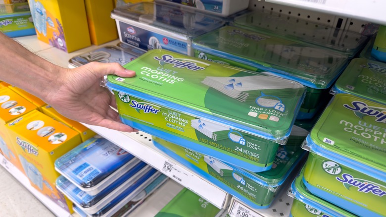 person picking Swiffer wet cloths in a store