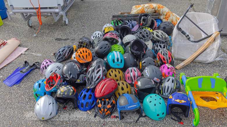 Pile of used colorful helmets at flea market