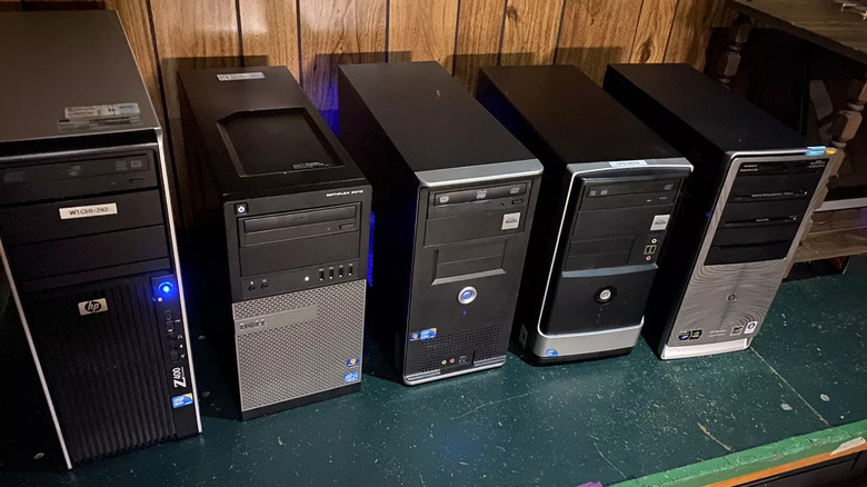 Custom personal computers lined up and powered on tabletop