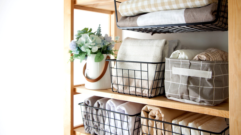 Linens in bins on shelves