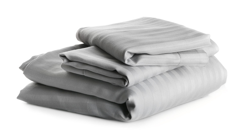 Folded gray sheets and pillowcases