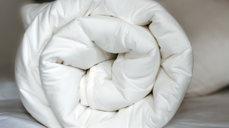 Rolled white quilt