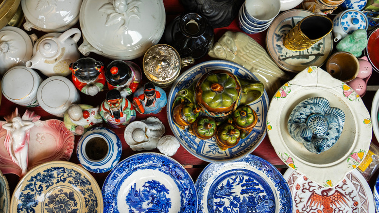 Vintage porcelain, pottery, and ceramics at a thrift store table