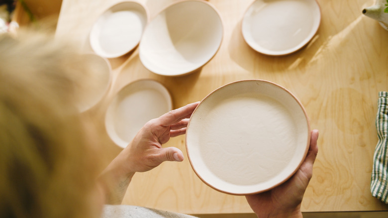Woman holding a pottery plate