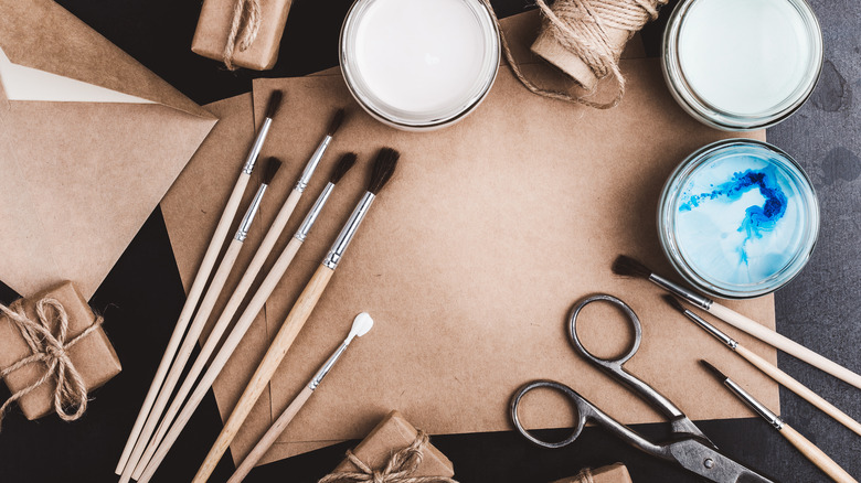 Craft supplies like scissors and twine on a table.