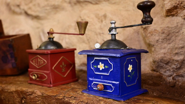 Antique, hand-operated coffee mills painted in bright colors