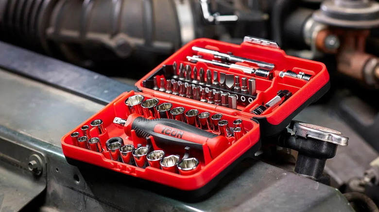 A red Icon Drive Compact Socket and Bit Set sits on a car frame