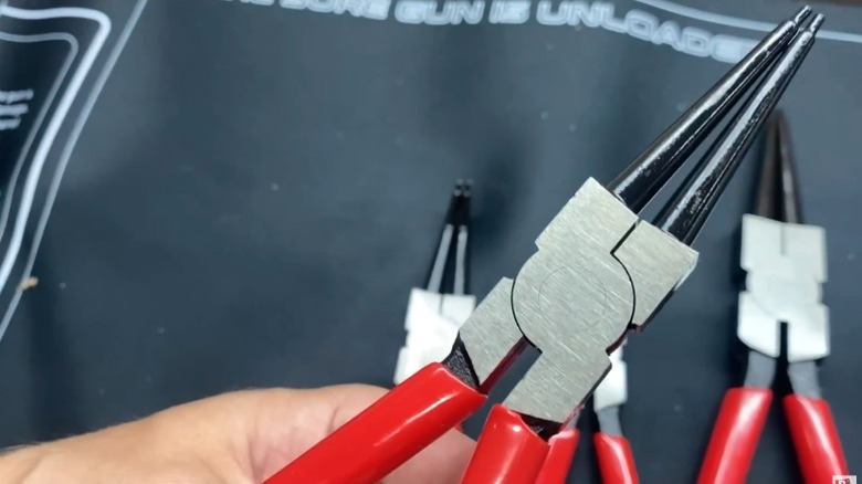 Close-up of person holding Icon snap ring pliers