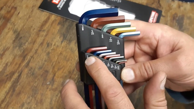 A person holding the Icon color-coded hex key set