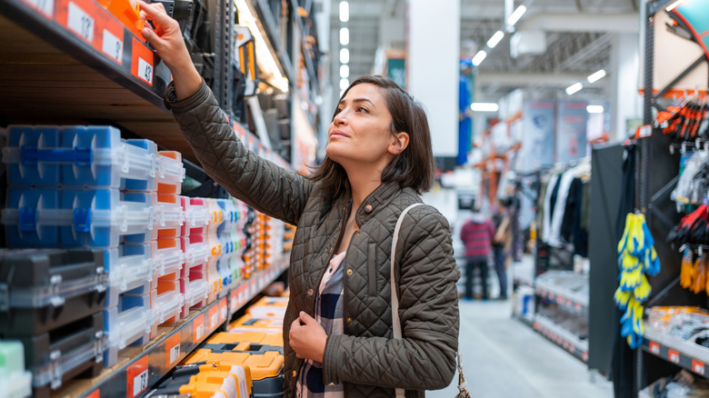 A woman reaches for an item while shopping at Harbor Freight