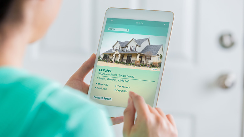 person looking at house listing