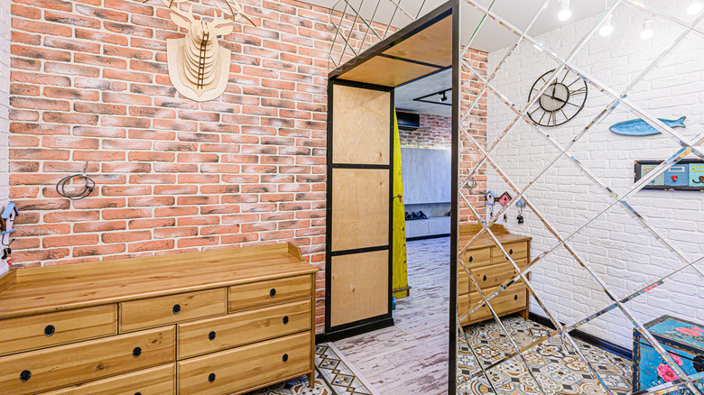 A brick room with glass tile accent wall