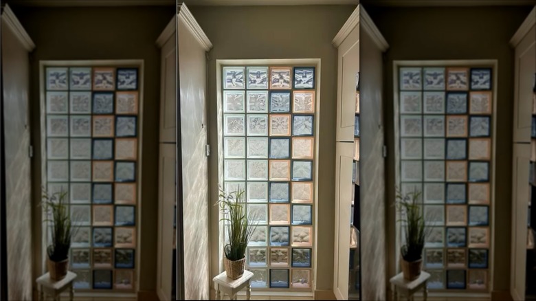 Multi-colored glass block feature wall in a home entryway.