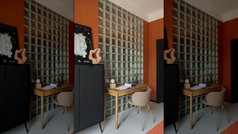 Home office space with glass block wall in front of desk.