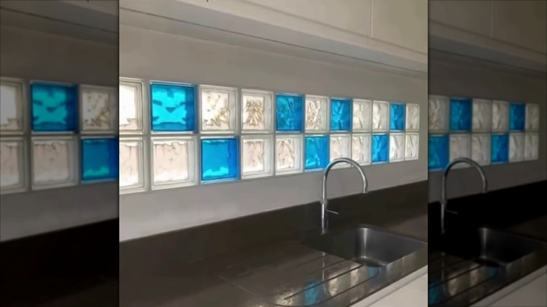 Kitchen backsplash made with blue and clear glass blocks.