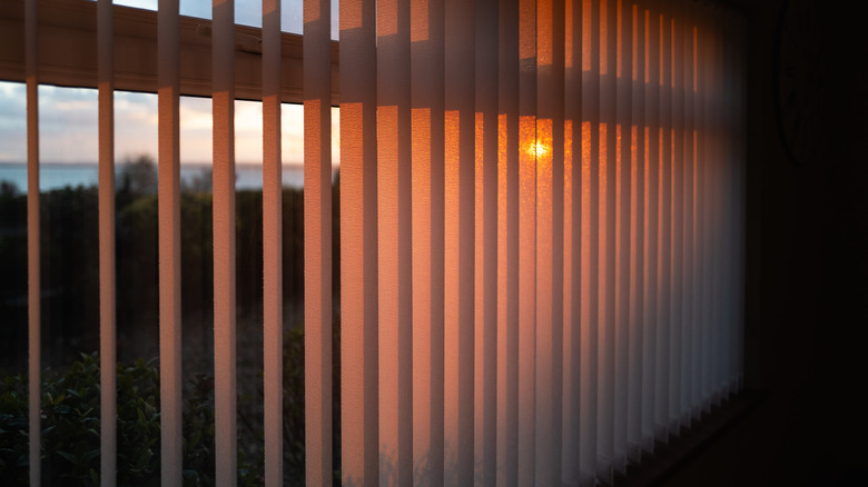 Vertical blinds with the sunset seen through them