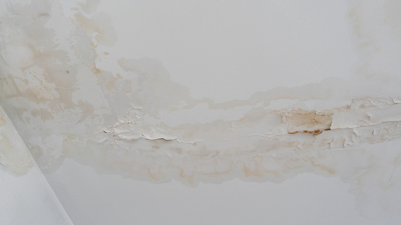 Cracked plaster and water damage on home ceiling