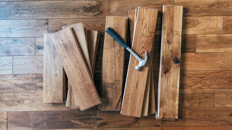 Hammer on a pile of solid oak floor planks