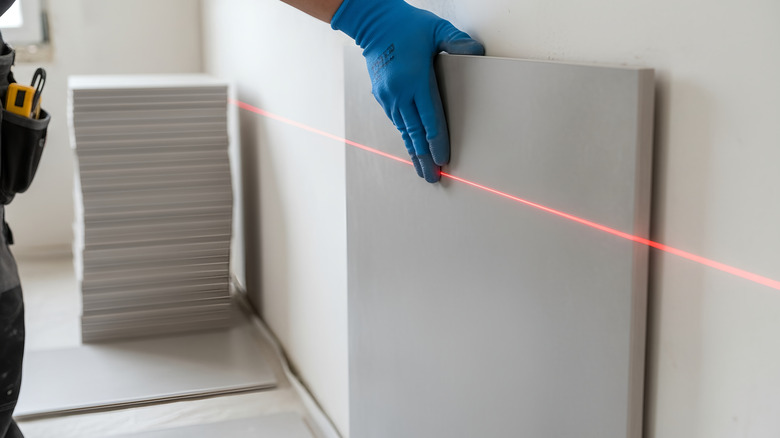 Construction worker making sure a wall is square