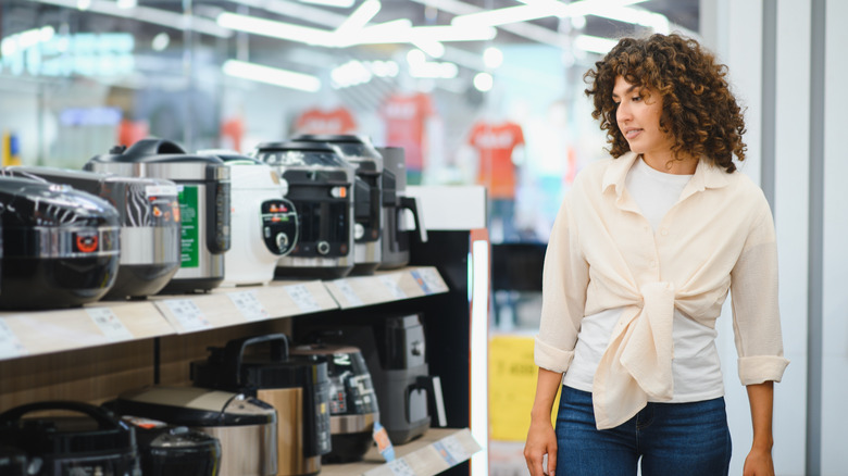 Woman looking at appliances in home store