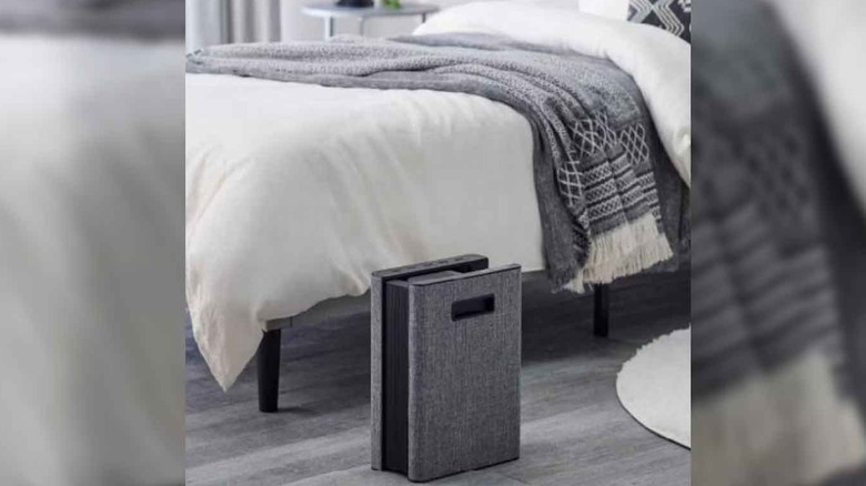 Futon dryer at the foot of a bed