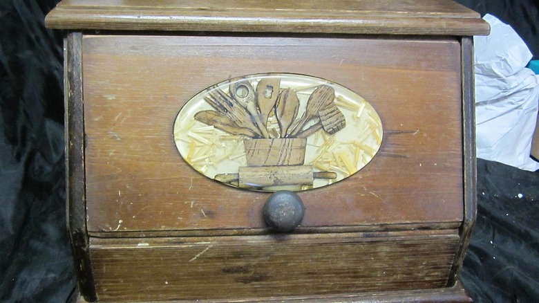 A vintage wooden inlay breadbox.