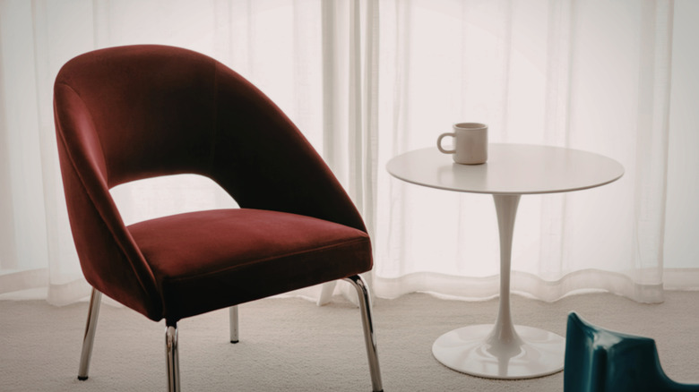 Brown retro chair with tulip pedestal table in a room