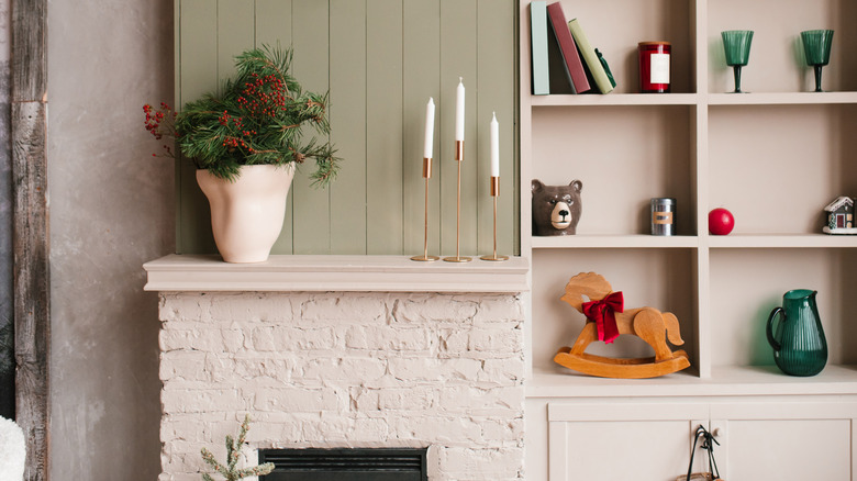 White-painted mantel shelf over brick fireplace