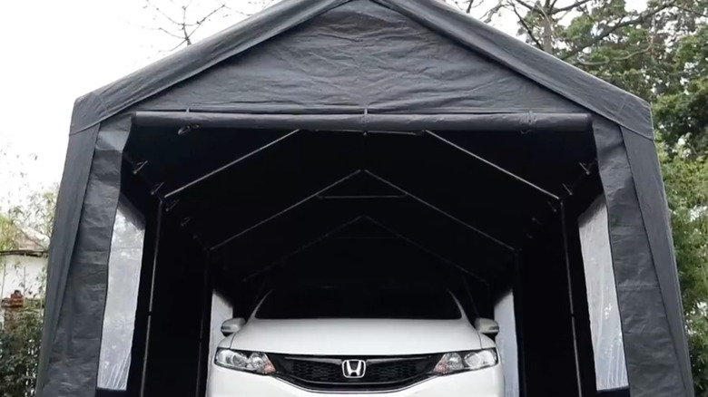 Gray carport canopy with white Honda vehicle inside