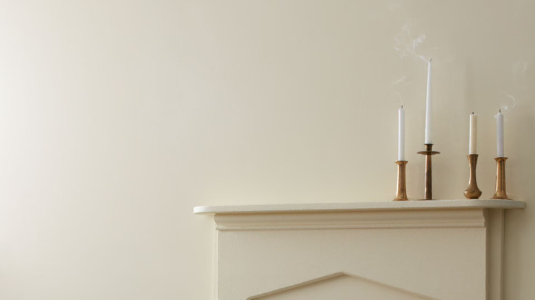 A wall painted Revere Pewter with candlesticks on a fireplace