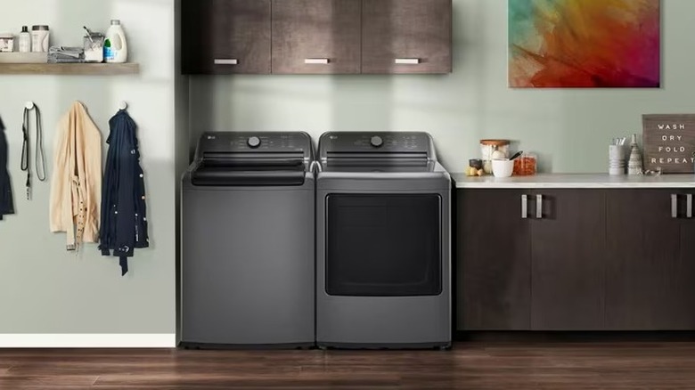 Gray washer and dryer sitting side-by-side in a laundry room