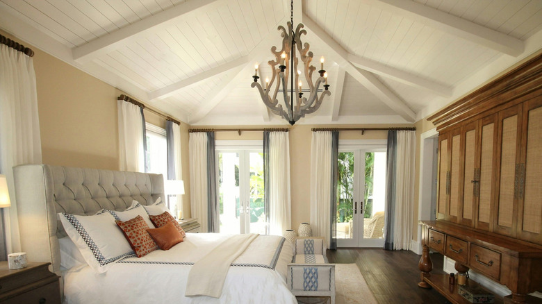 White shiplap is installed on the ceiling of a large bedroom