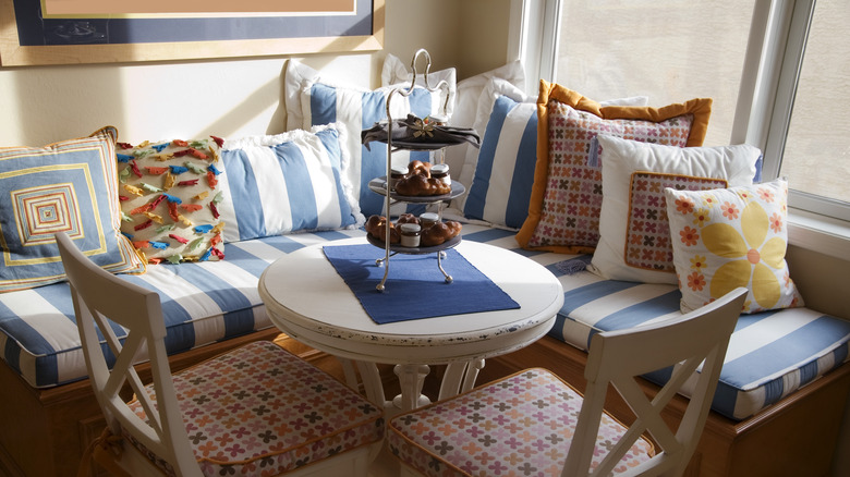 A corner bistro table and chairs with cushions
