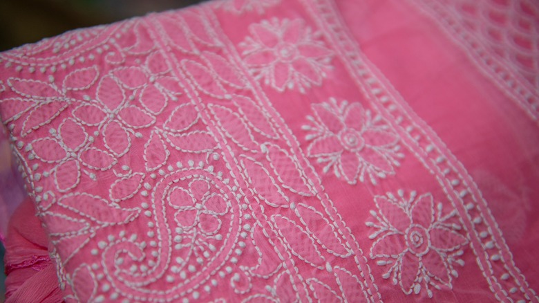 pink quilt with embroidered design