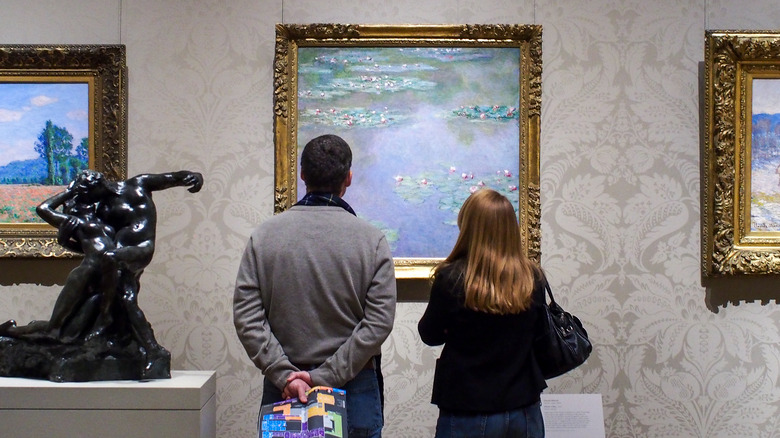 people looking at impressionist art