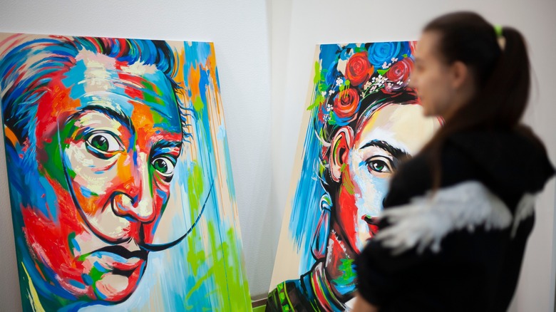 woman looking at portrait of Dalí