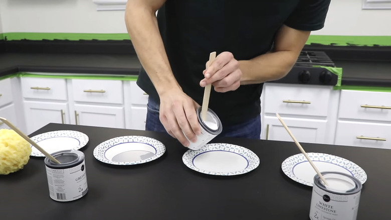 man mixing materials for faux granite countertop