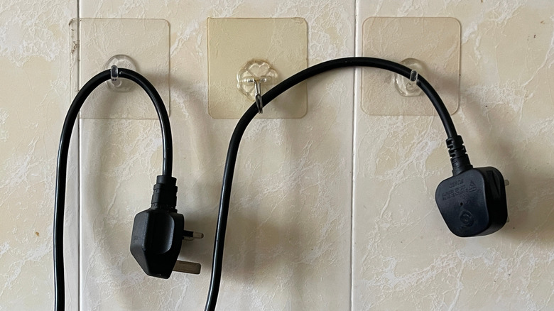 Close up of cords hanging on adhesive hooks on wall