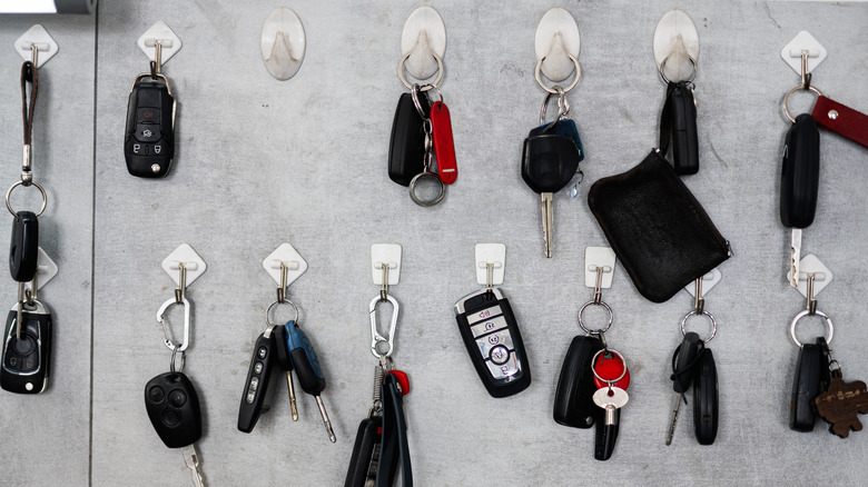 Close up of multiple keys hanging on wall using adhesive hooks