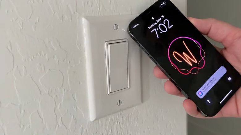 Closeup of a phone scanning a switch plate cover