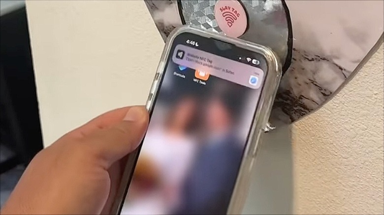Closeup of person scanning an NFC tag