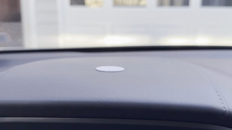 Closeup of an NFC tag on a vehicle dashboard