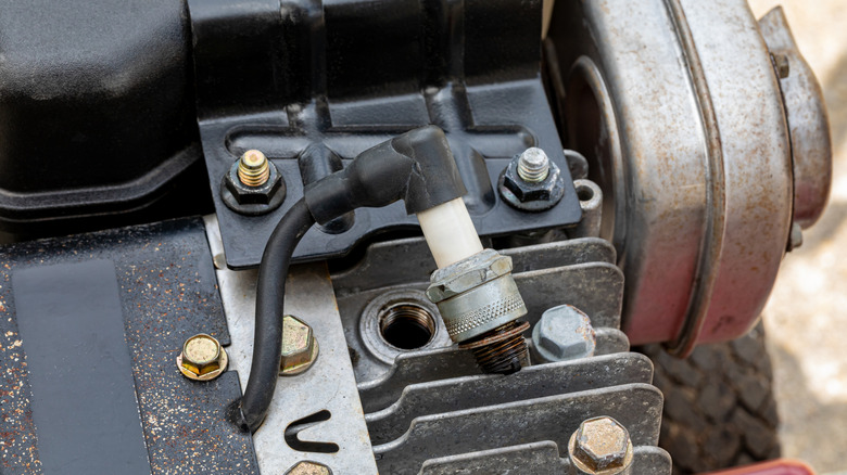 Spark plug removed from lawn mower