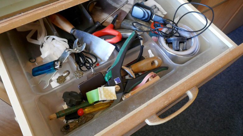 Messy drawer with random items