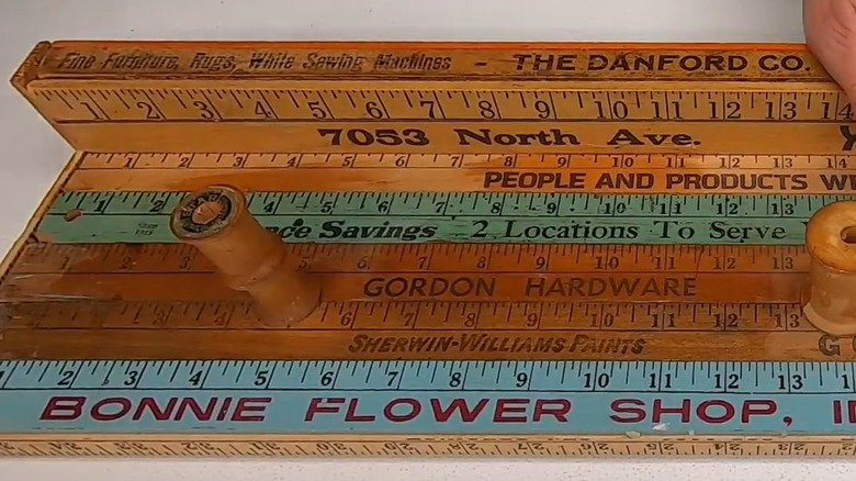 Yardsticks repurposed into a hanging shelf