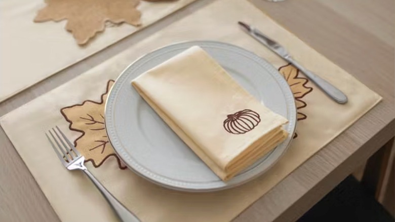 Cloth napkin with pumpkin motif on plate
